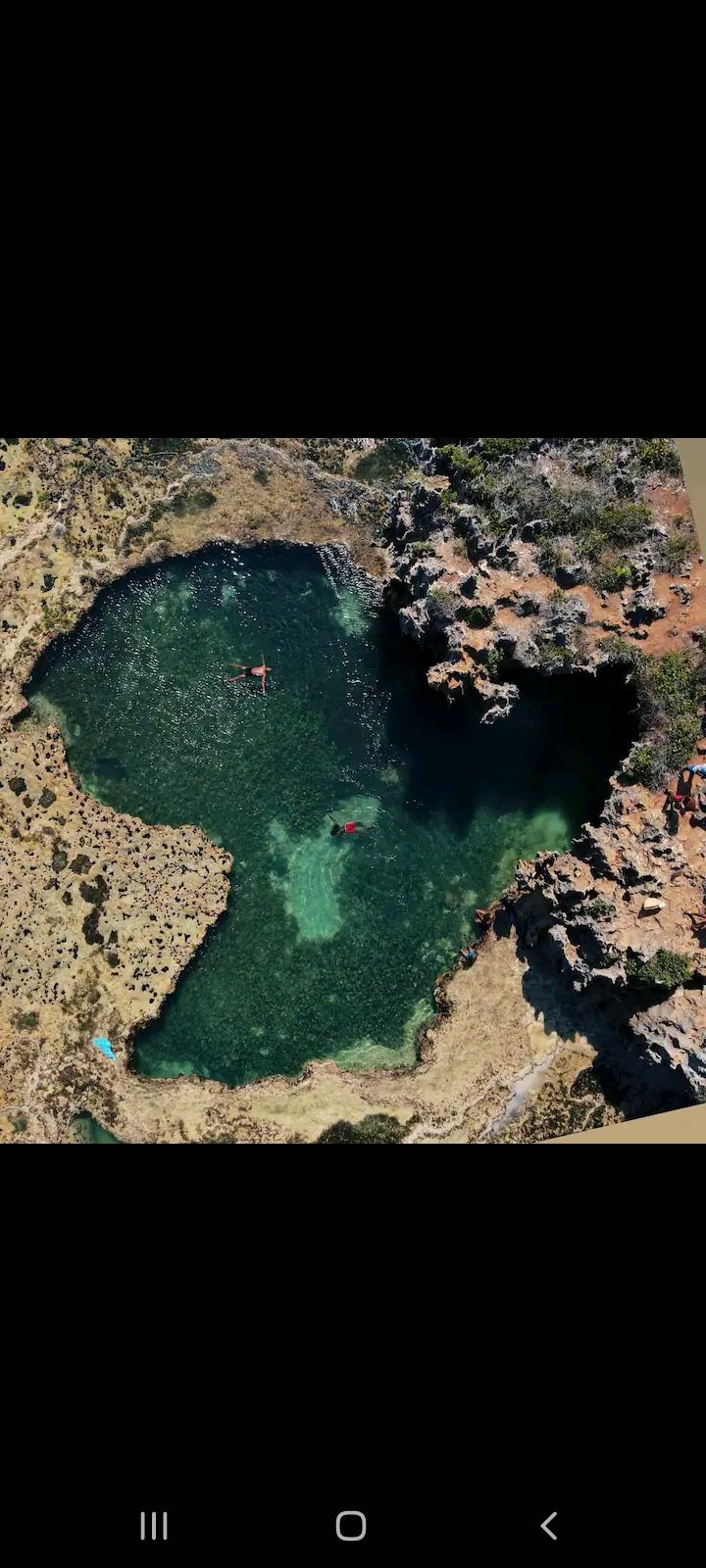 Natural coral tide pool on the reef flat at Tiwi Beach at low tide