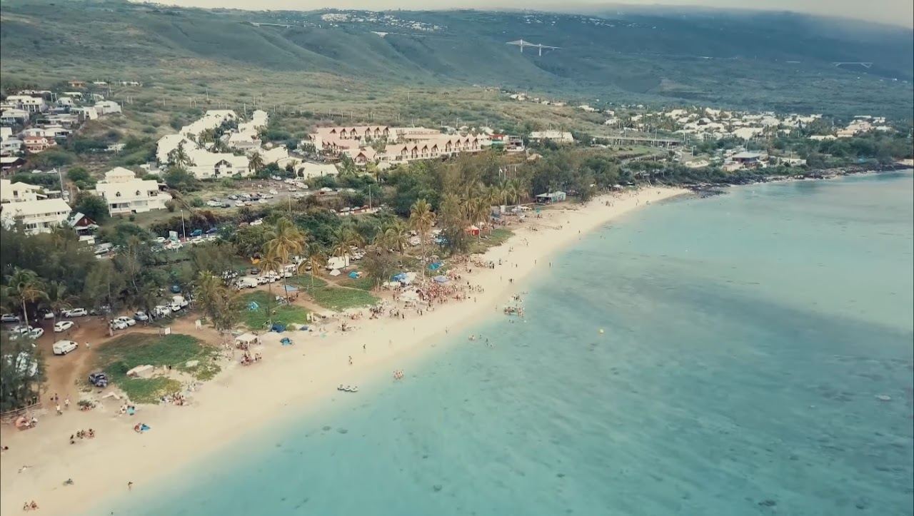 The shallow turquoise lagoon and white sand at Trou d'Eau beach, La Saline les Bains, Reunion
