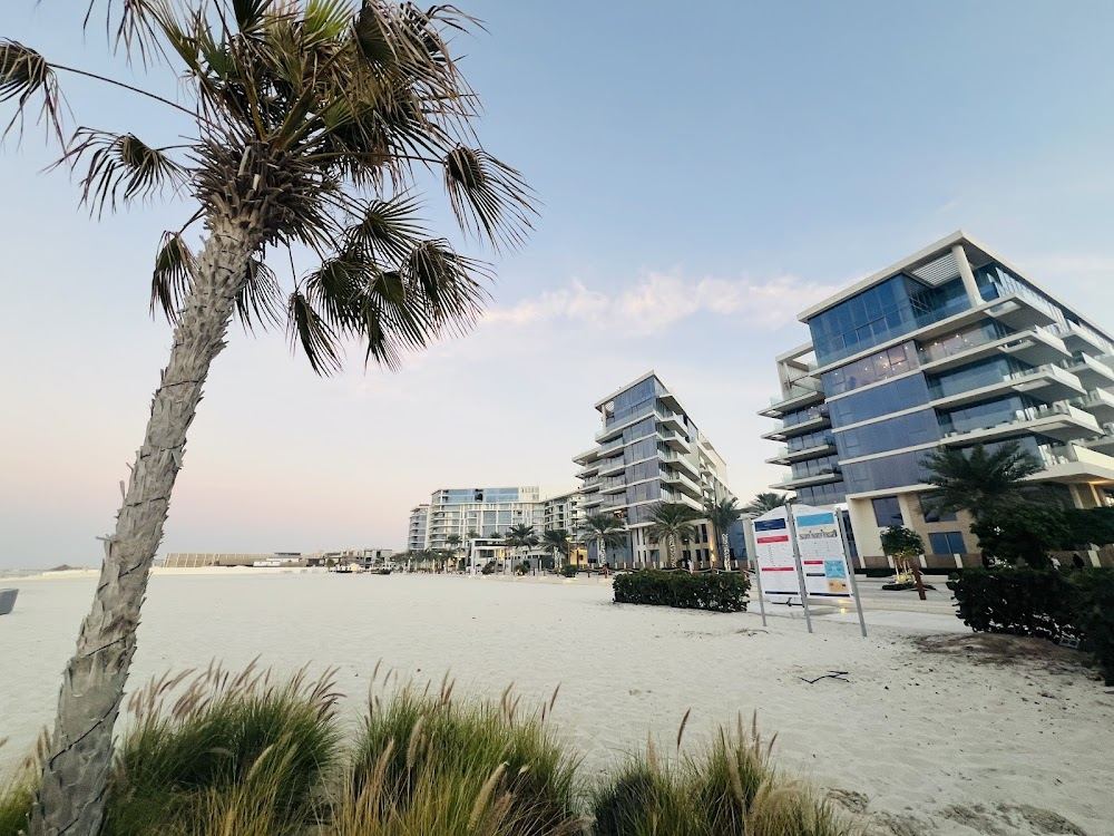 Pale loungers and a beach bar on the white sand of Soul Beach, Saadiyat Island