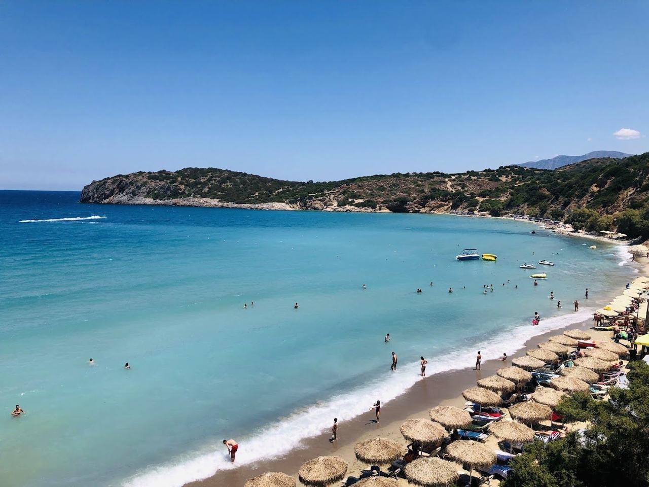 Soft golden sand and shallow turquoise water in the sheltered bay at Voulisma beach near Istron in east Crete