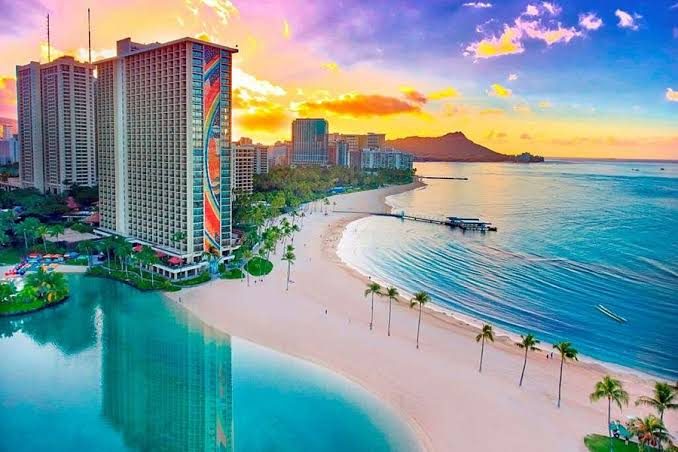 Waikiki Beach curving below Diamond Head on Oahu at golden hour