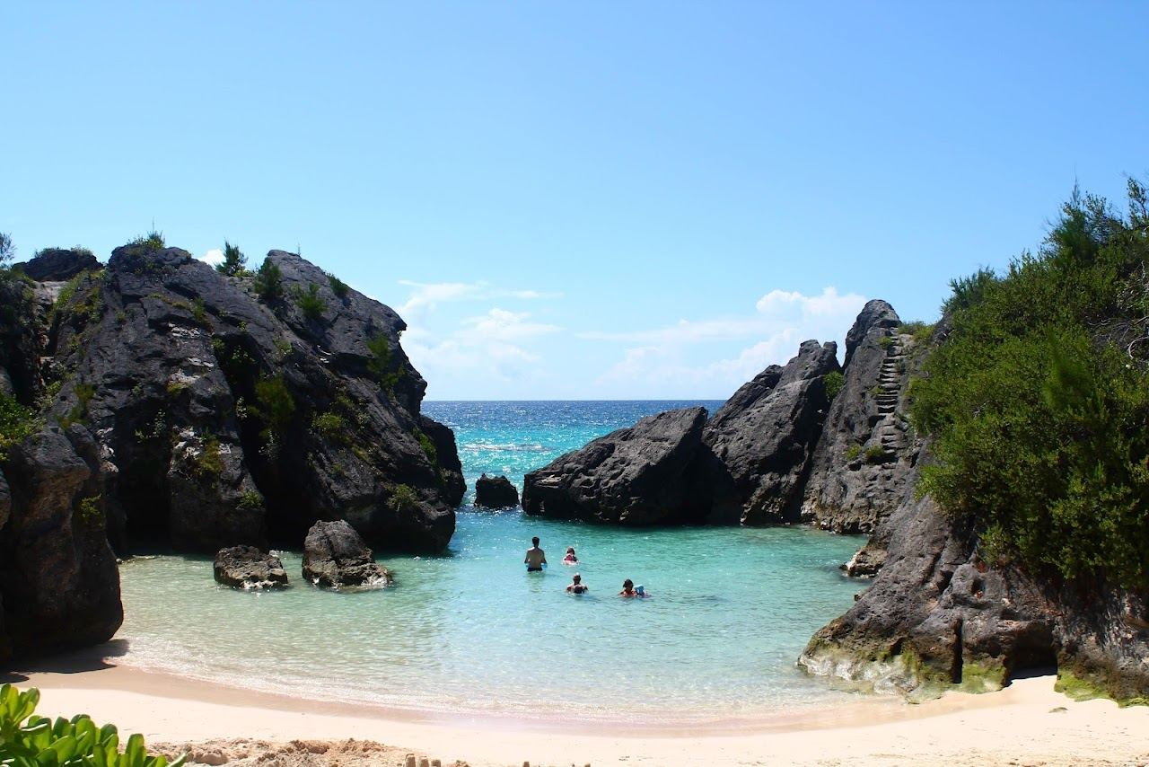 The long sweep of pink sand and a limestone stack offshore at Warwick Long Bay in Bermuda