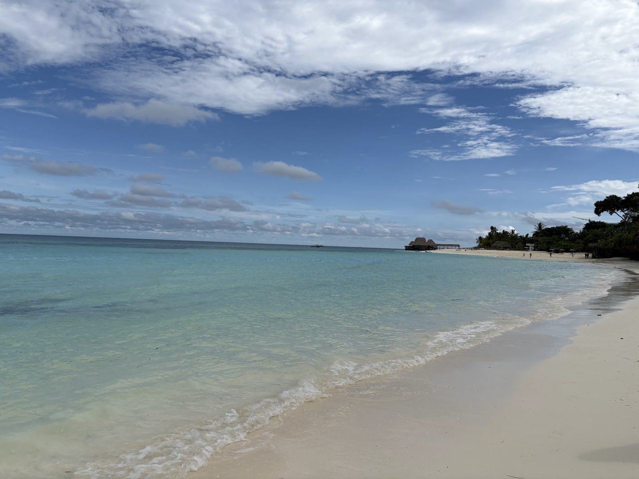 Wide pale sand and shallow turquoise water at Kendwa beach in northern Zanzibar